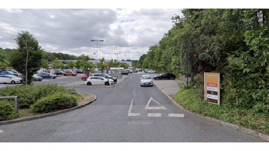 Parking lot entrance with cars, greenery, and a sign for "YourParkingSpace" in Moortown, Yorkshire.