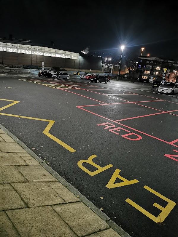 Drummond Street Car Park at night with visible parking spaces marked in red and yellow, and cars parked.