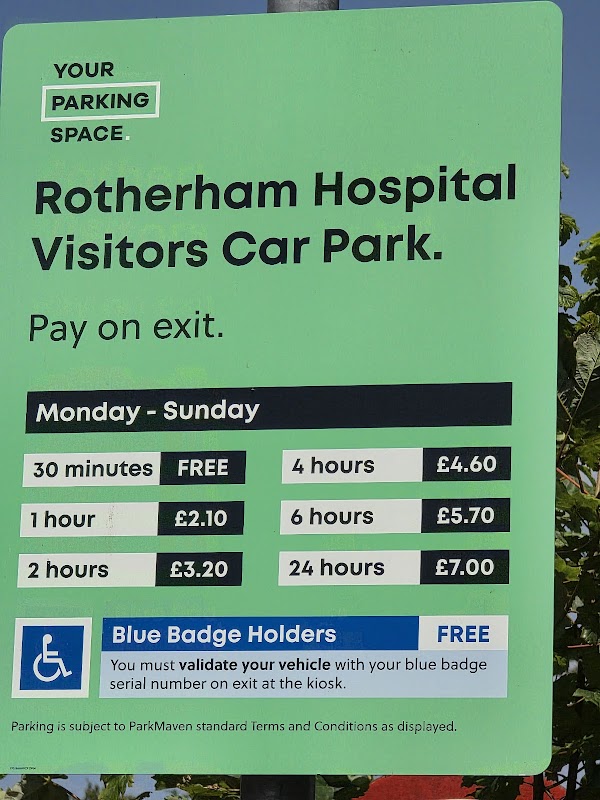 Rotherham Hospital Visitors Car Park sign detailing parking fees and times, with accessibility information for Blue Badge holders.