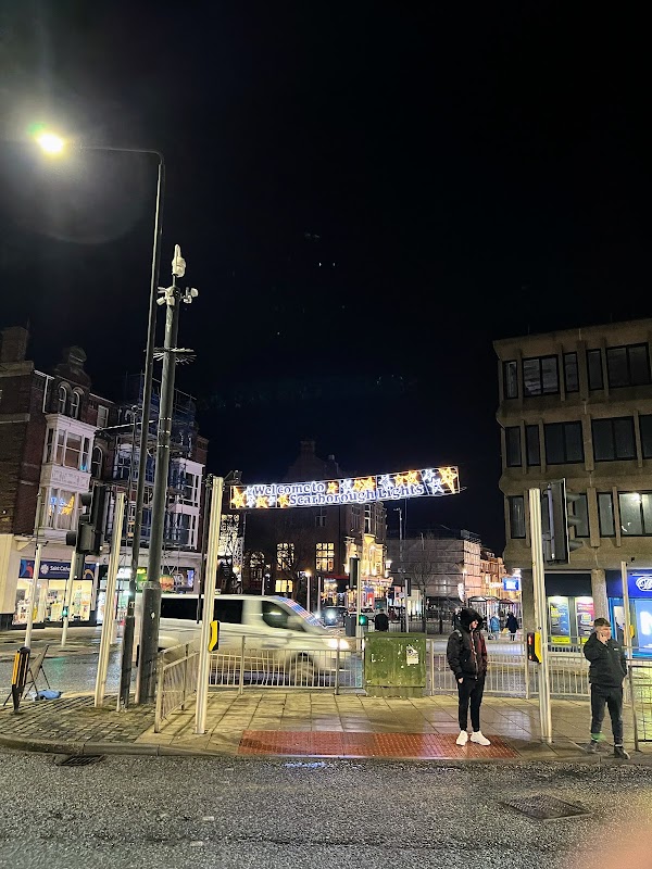 Scarborough Station Car Park at night, featuring streetlights, buildings, and a busy urban atmosphere.