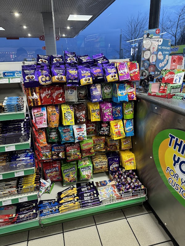 Colorful display of snacks and sweets in a convenience store, with various brands and types prominently arranged.