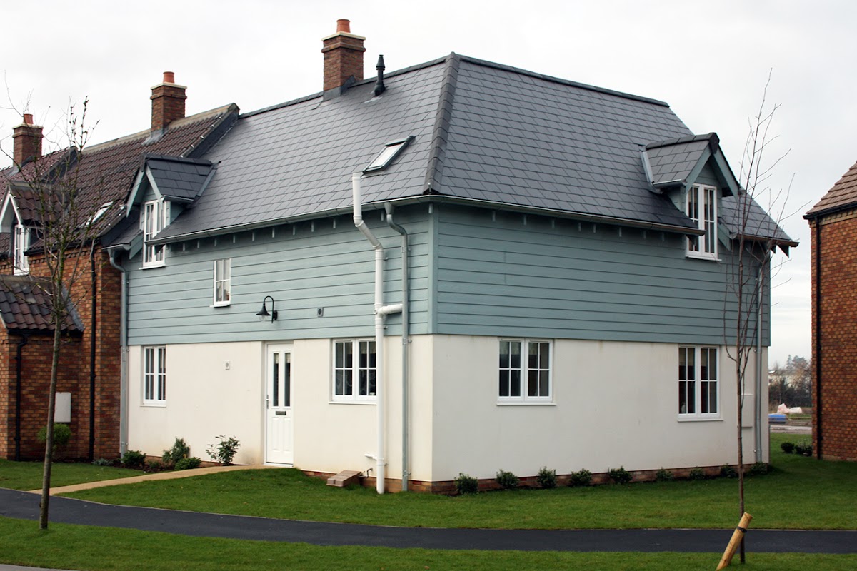 Lovesea Lodge, a two-story house with a blue exterior, white trim, and a well-maintained lawn in Filey, Yorkshire.