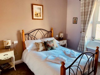 Cozy Clarendon Country Pub room in Grassington, Yorkshire, featuring a double bed, rustic decor, and soft lighting.