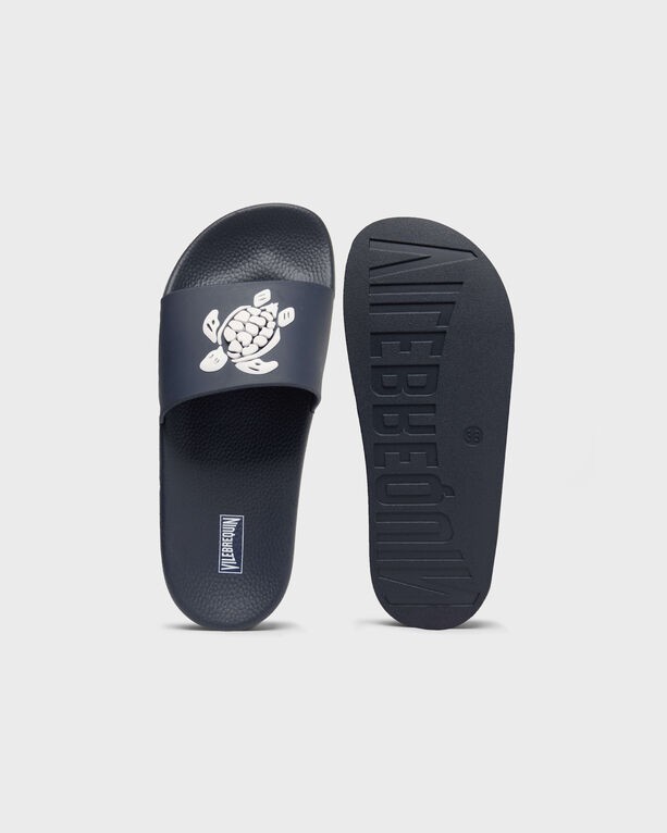 Blue beach slider shoes by Vilebrequin, featuring a white turtle graphic on the strap and textured sole, available in size 40.