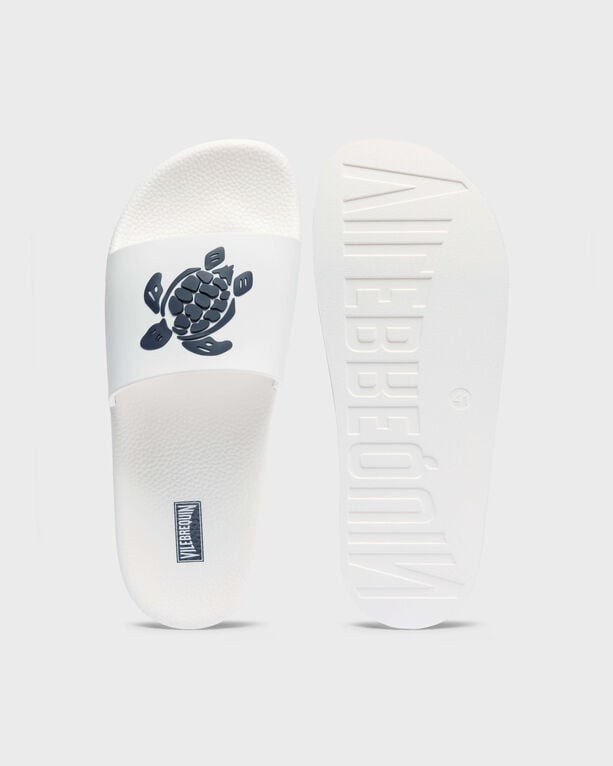 White Vilebrequin Beach Slider shoes featuring a black turtle graphic on the strap, with a textured footbed and embossed logo on the sole, size 42.