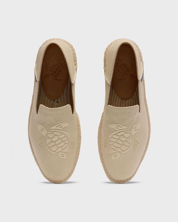 Beige canvas boat shoes by Vilebrequin, featuring a turtle logo embossed on the insole and a textured sole, designed in a slip-on style, size 42.