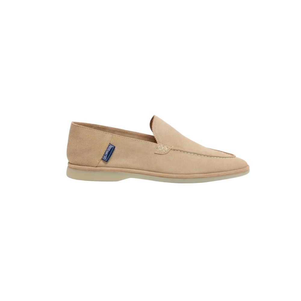 Beige suede loafers with a slip-on design, featuring a subtle stitched detail and a light-colored rubber sole, branded with a small blue tag.