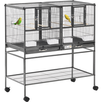 Large bird cage with black metal bars, two compartments, food and water bowls, on wheels, suitable for finches and parakeets.