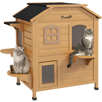 Wooden cat house with two levels, arched windows, black roof, and side platforms, featuring two cats lounging.