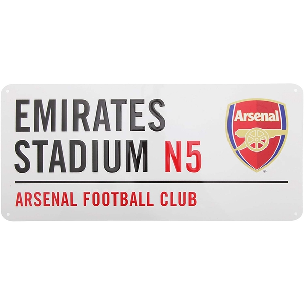 White metal street sign featuring "EMIRATES STADIUM N5" in bold black letters, with the Arsenal FC logo in red and yellow on the right side.