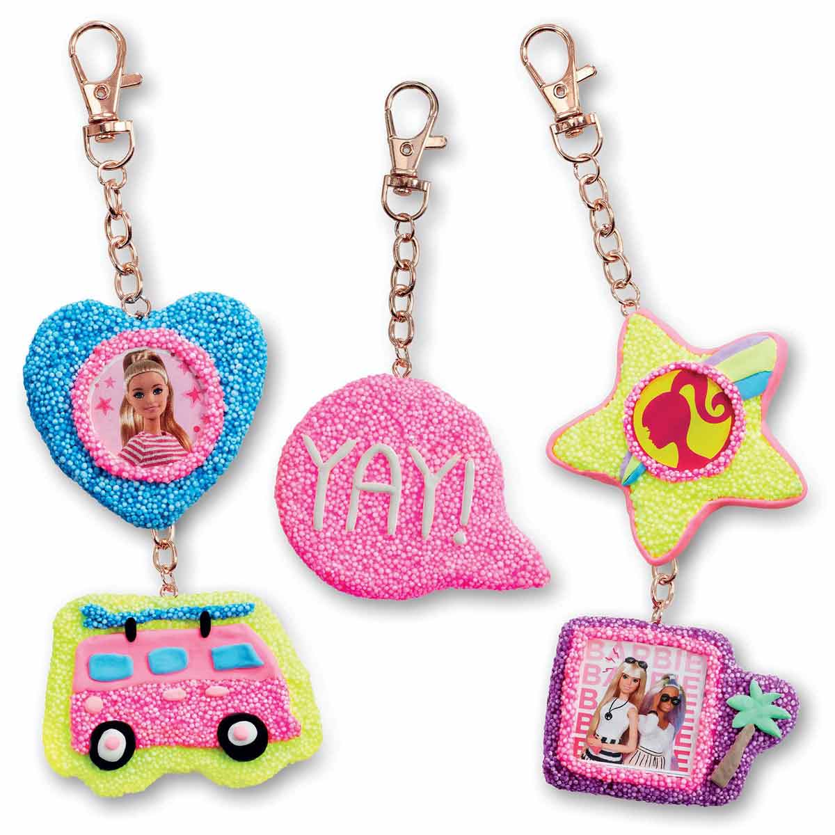 Colorful friendship keyrings craft set featuring a heart, speech bubble, star, and van, adorned with beads and clips, allowing customization with Barbie-themed images.