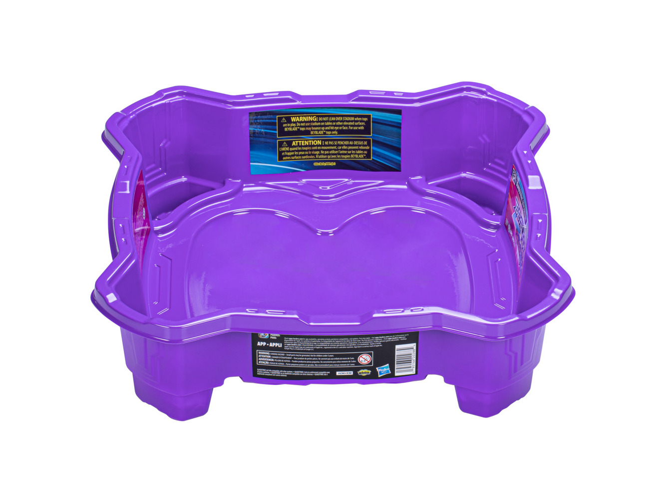 Purple plastic Beystadium with a hexagonal shape, featuring smooth surfaces and raised edges for Beyblade battles, includes warning labels on the sides.