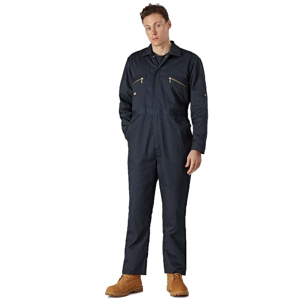Dark navy Dickies Men's Redhawk Coverall made from durable material, featuring zippered chest pockets, long sleeves, and a relaxed fit, paired with brown work boots.