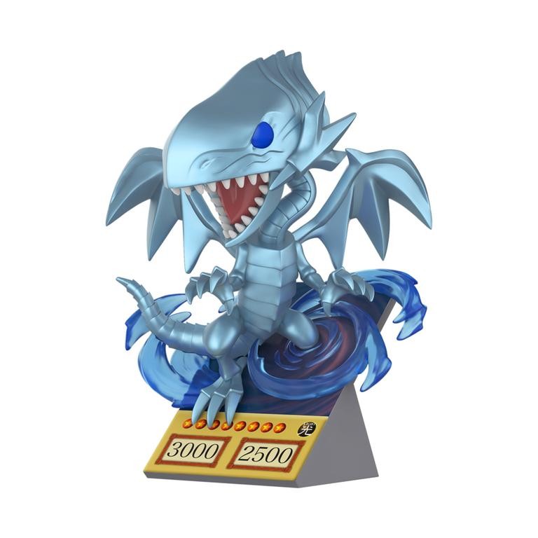 Premium vinyl figure of Blue Eyes White Dragon, featuring a blue dragon with large wings, sharp teeth, and a swirling blue base, displaying attack and defense stats on a card.