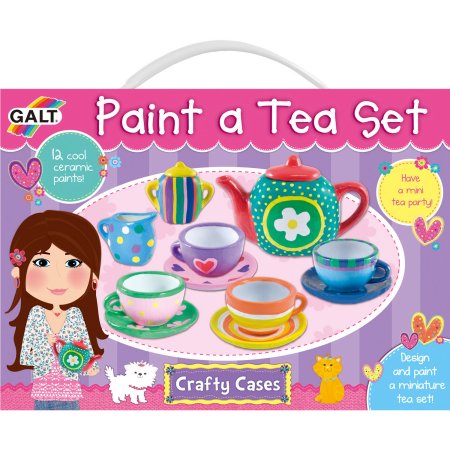 Colorful ceramic tea set including a teapot, cups, and saucers, featuring various playful patterns and a carrying case with a cartoon girl and cat illustrations.