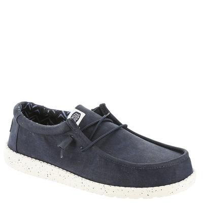 Blue canvas slip-on shoes for men by HEYDUDE, featuring a textured upper, lace-up design, and a white speckled sole for added contrast.