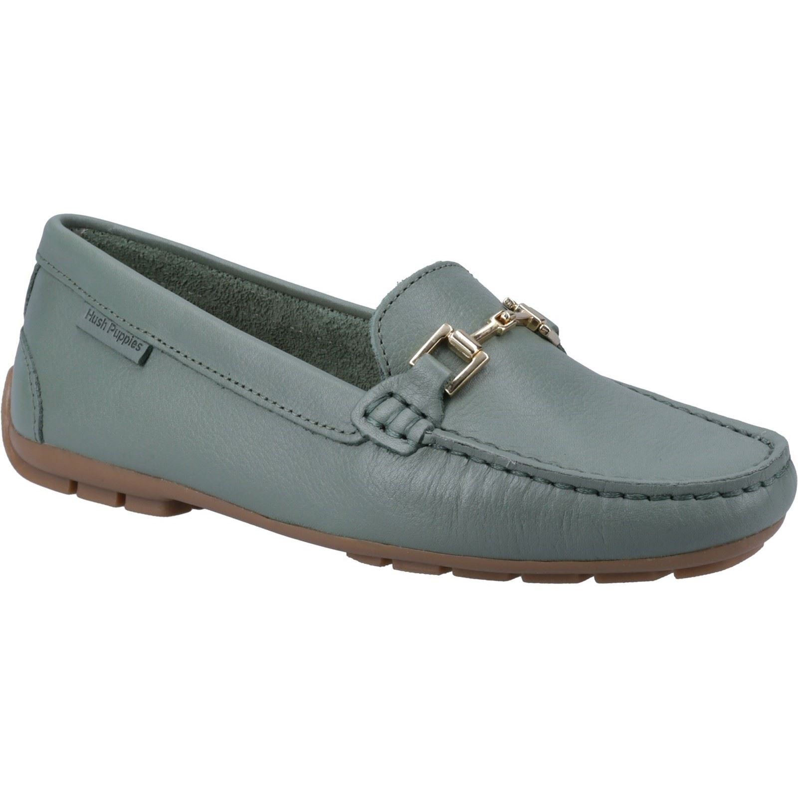 Light sage green leather loafers featuring a stitched design, decorative gold-tone buckle, and a flexible brown rubber sole for comfort.