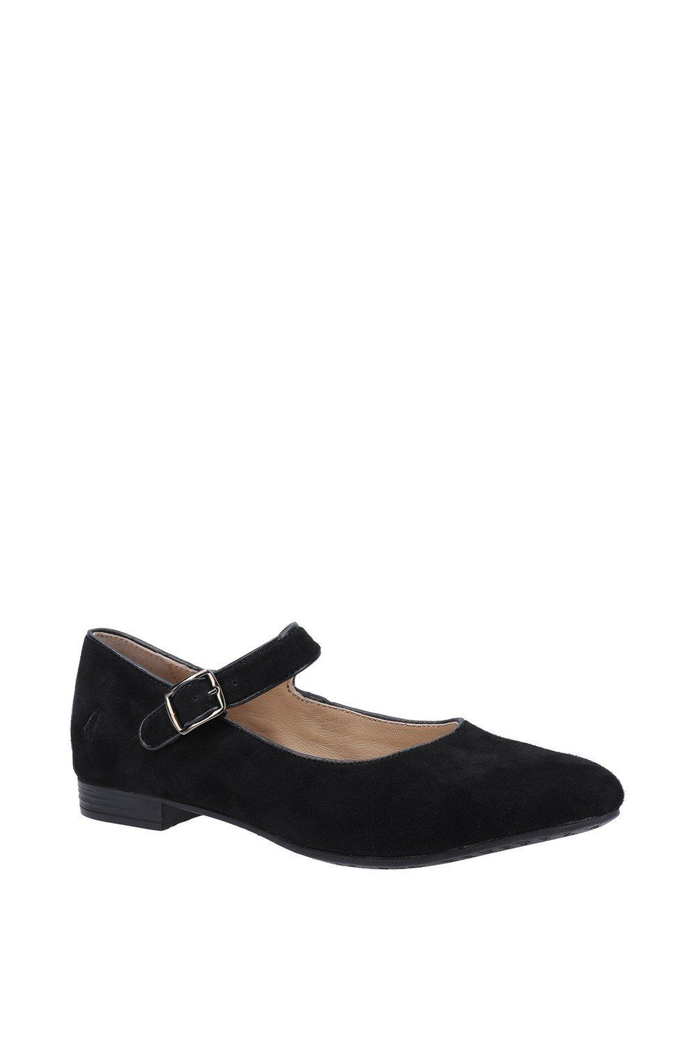Black suede Mary Jane strap shoe with a low heel, featuring a single adjustable buckle and a pointed toe design, ideal for casual or dressy occasions.