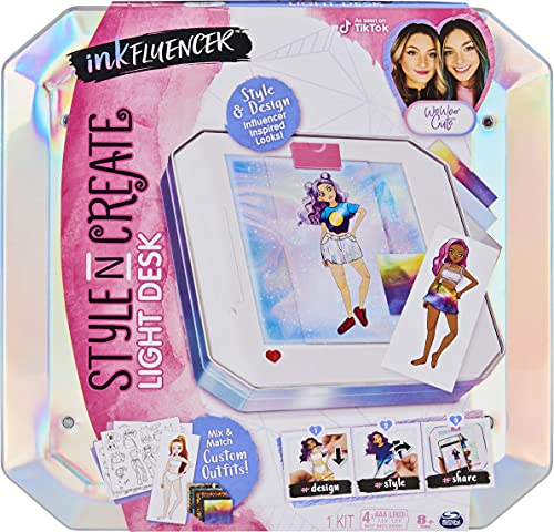 Colorful, iridescent desk kit featuring a light-up drawing board, markers, and design templates for creating custom outfits, aimed at aspiring influencers and artists.