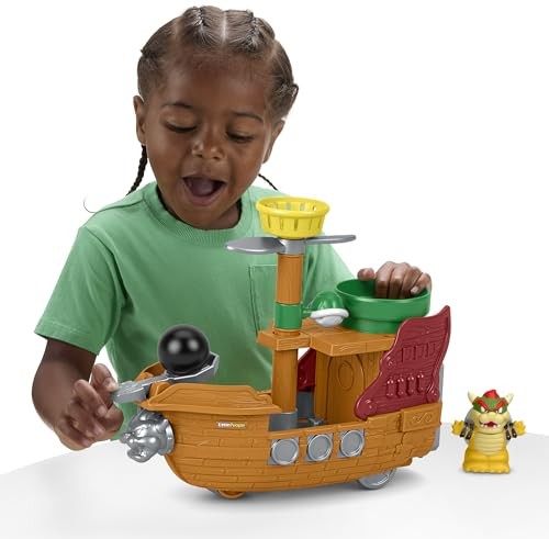 A young child plays with a colorful wooden airship toy featuring a green basket, a cannon, and a Bowser figure, all set against a white background.