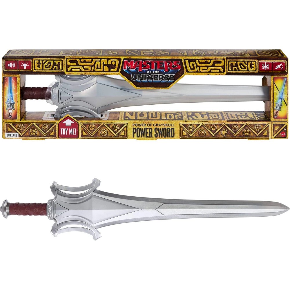 Silver sword with a detailed hilt, red grip, and decorative gold accents; packaged in a colorful box featuring "Masters of the Universe" branding and a "Try Me!" label.