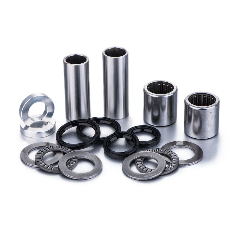 Factory Links Swing Arm Bearing Kit for Honda CR125R featuring shiny silver metal bearings, black rubber seals, and various cylindrical spacers and washers.