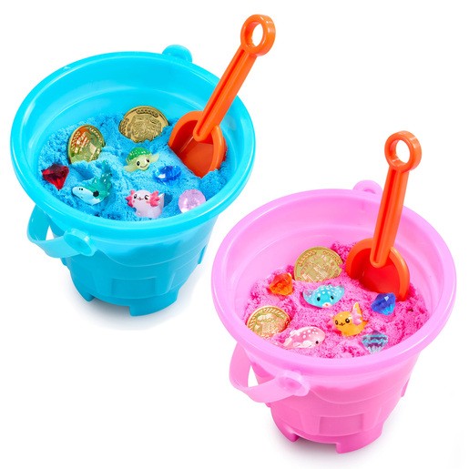 Bright blue and pink plastic buckets filled with colorful sand, featuring small toys like fish and gems, along with a shovel in each bucket.