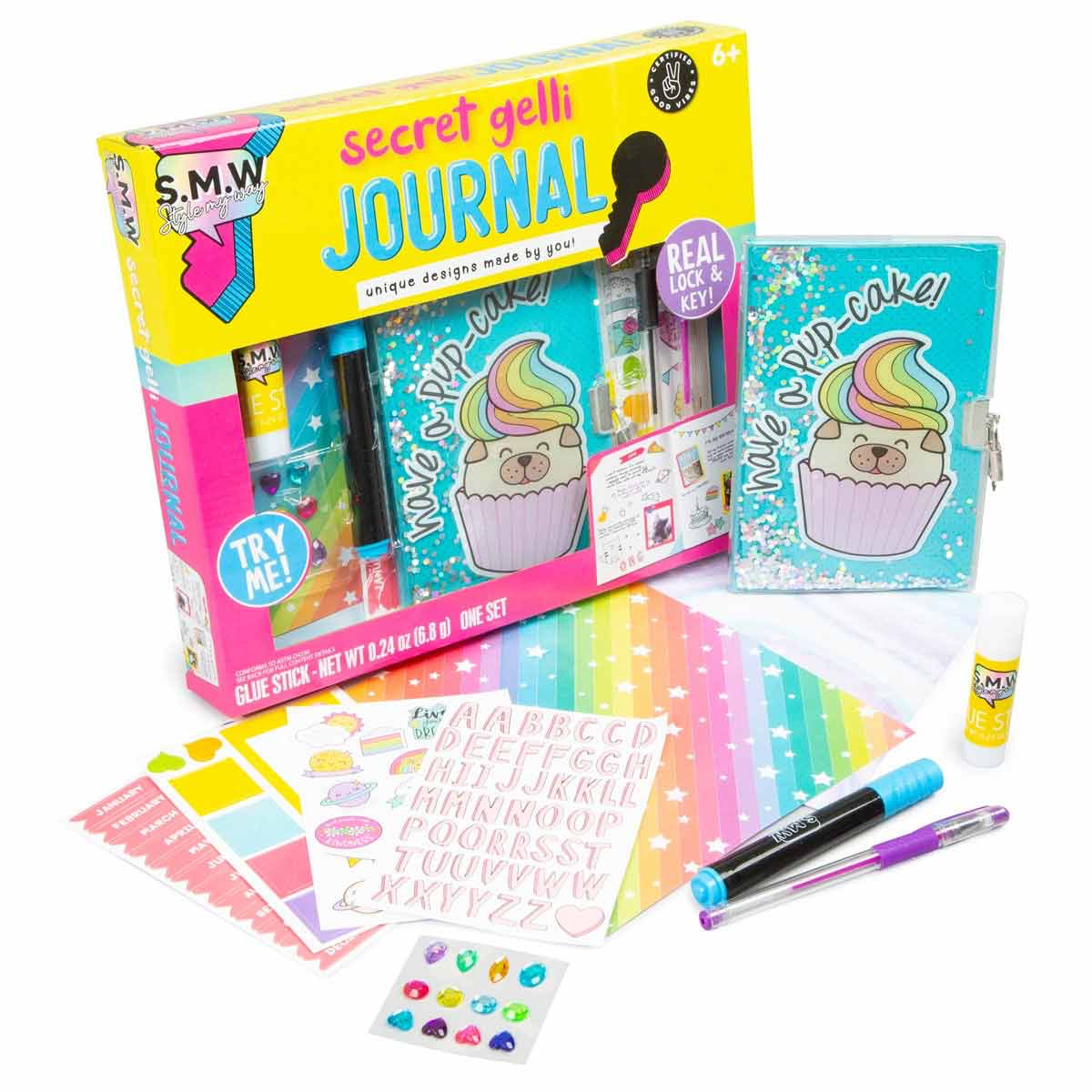 Colorful craft set featuring a secret journal with a cupcake design, lock and key, glue stick, stickers, and vibrant patterned paper, suitable for ages 6 and up.