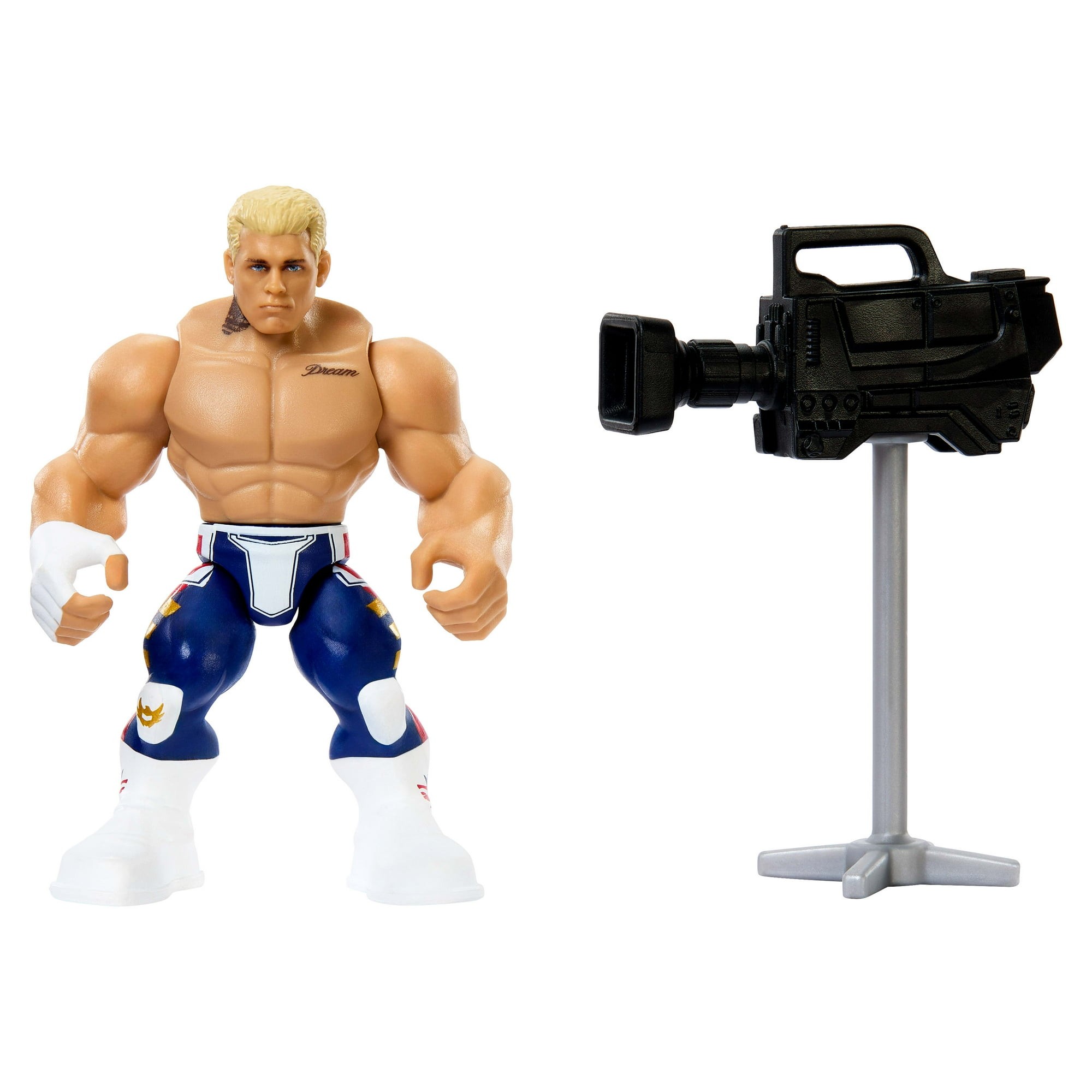 Cody Rhodes action figure with blonde hair, muscular build, wearing blue pants with white and red accents, alongside a black camera accessory on a gray stand.
