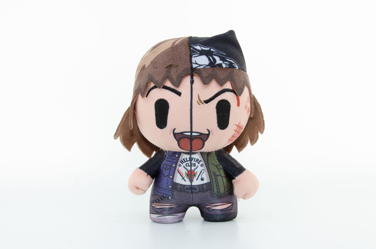 Eddie-themed plush toy from Stranger Things, 19cm tall, featuring a split design with brown hair, a black bandana, and a colorful outfit with patches and scars.