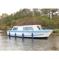 White and blue Hoseasons Calypso riverboat with large windows and blue fenders, cruising on a calm river.