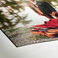 Hahnemühle FineArt Pearl paper with glossy finish, featuring a vibrant printed image of a person and guitar.