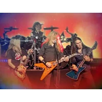 Band performing on stage with electric guitars, drummer in background, vibrant red and blue lighting effects.