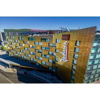Golden exterior of Radisson Red Sky Bar, Glasgow, with modern architecture and rooftop view.