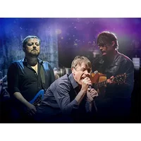 Three men performing on stage, one singing into a microphone, another playing guitar, and the third with a blue guitar.