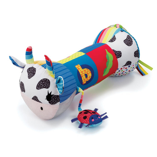 Colorful plush tummy time roller shaped like a cow, featuring polka dots, a bright patchwork design, and a ladybug attachment with various textured ribbons.