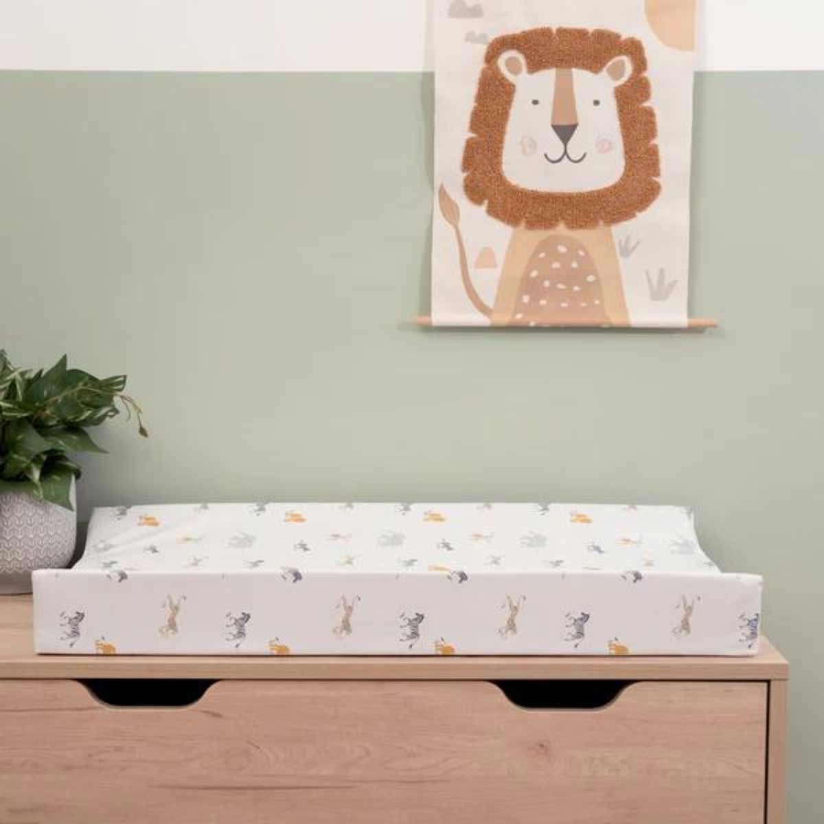 Clair De Lune Jungle Dream changing mat features a soft, multi-colored fabric with animal prints, an anti-roll wedge design, and a waterproof surface, set against a neutral backdrop.