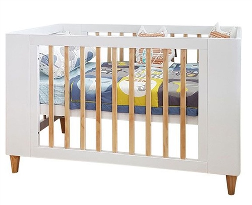 Cocoon Evoke 4-in-1 Nursery Furniture System in natural wood, featuring a white crib with slatted sides, wooden legs, and a colorful mattress with playful designs.