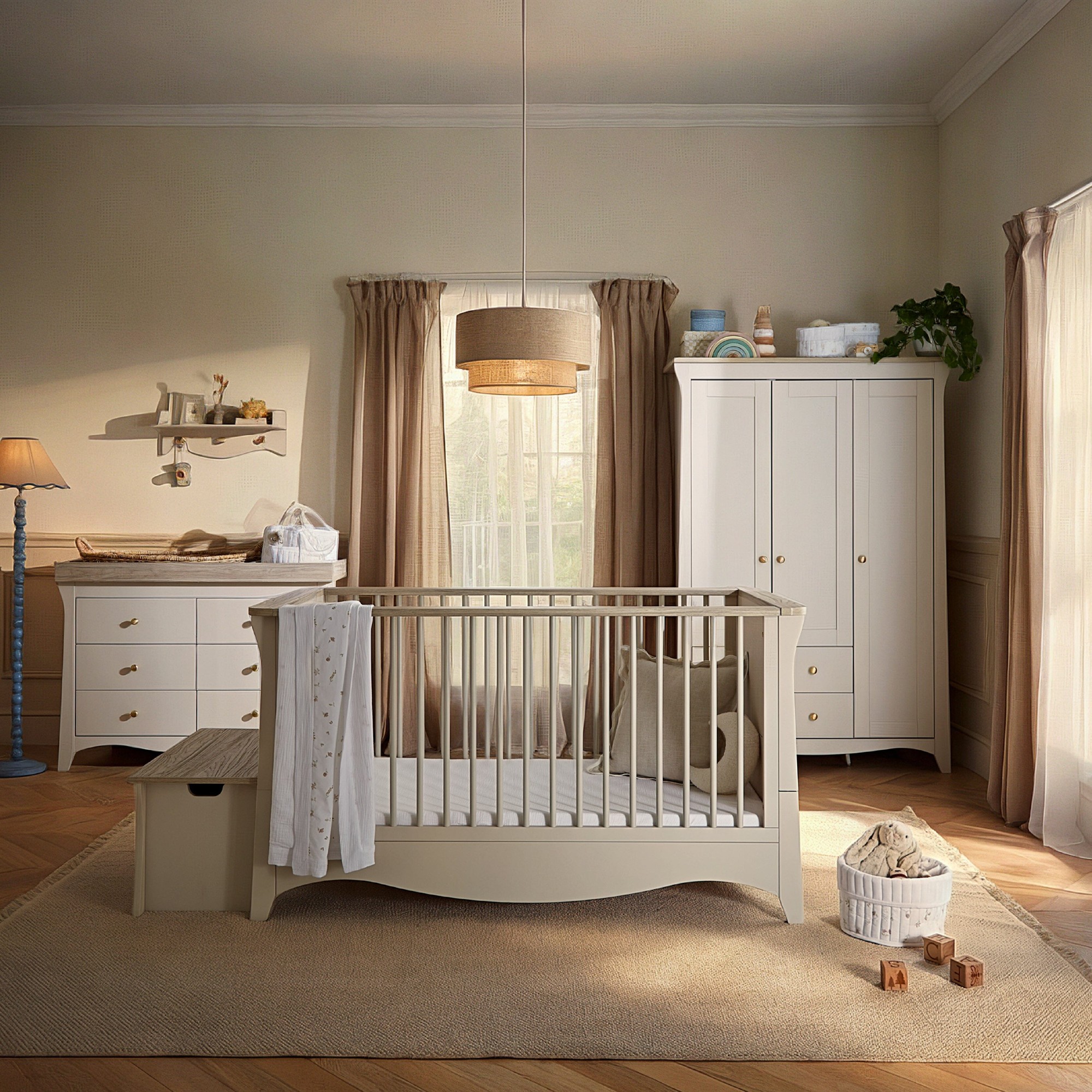 Clara Luxe 3 Piece Furniture Set in cashmere and ash features a crib, dresser, and wardrobe with a soft color palette, wooden accents, and a cozy, modern design.