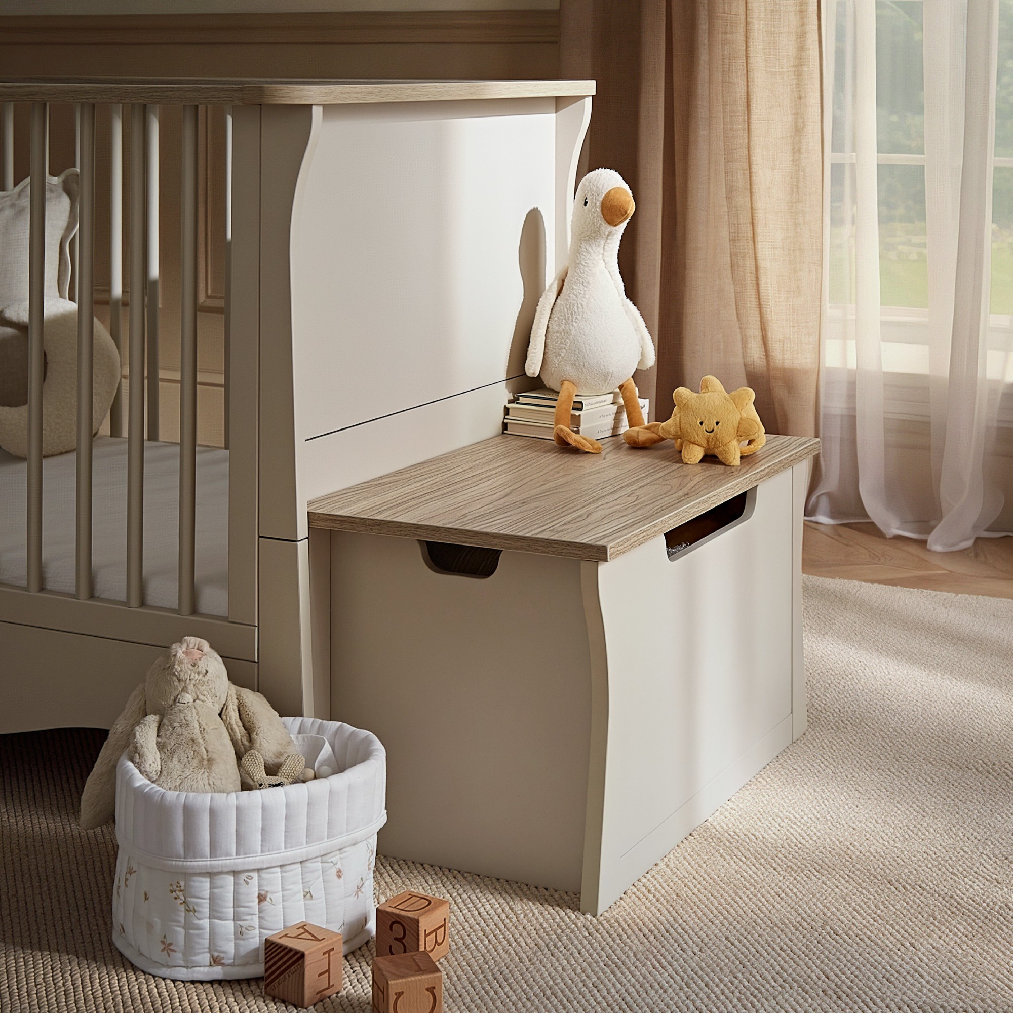 Clara Storage Box in cashmere and ash features a smooth, light beige exterior with a wood-grain top, designed for stylish organization in a nursery setting.