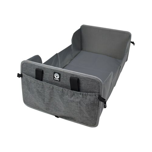 Portable travel cot in grey and black, featuring a soft fabric exterior, sturdy sides, and convenient storage pockets on the front for easy access.
