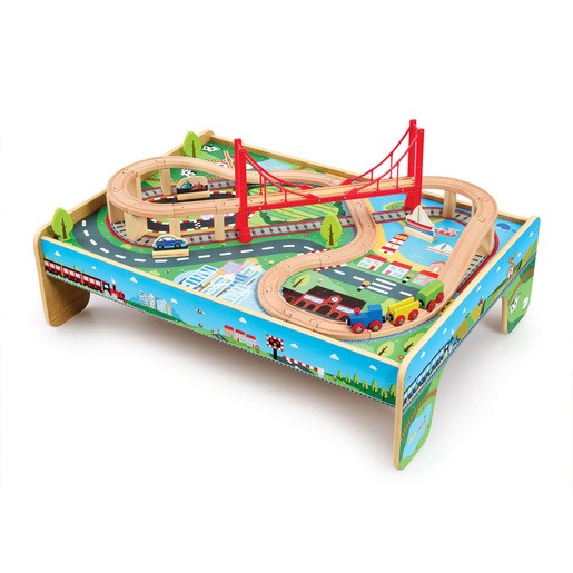 Wooden train table featuring colorful tracks, a red bridge, and vibrant scenery with trees, buildings, and vehicles, designed for early learning and imaginative play.