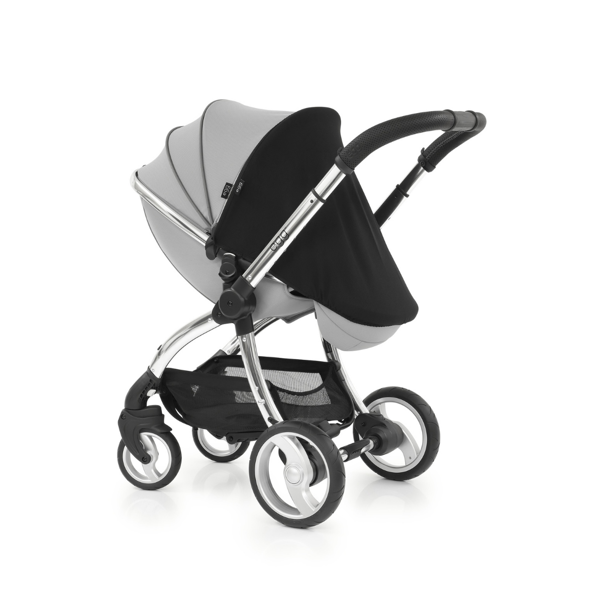 Gray stroller with a black sunshade, featuring a sleek aluminum frame, large wheels, and a spacious undercarriage for storage.