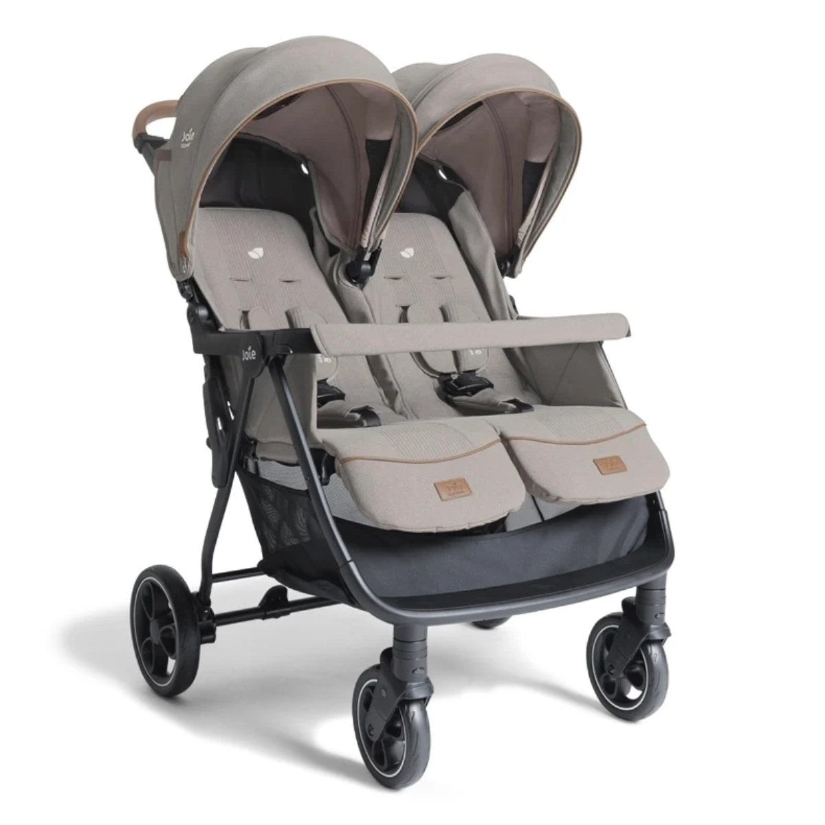 Double stroller in a neutral beige fabric with two canopies, adjustable harnesses, and a spacious storage basket, featuring a sturdy black frame and smooth-rolling wheels.