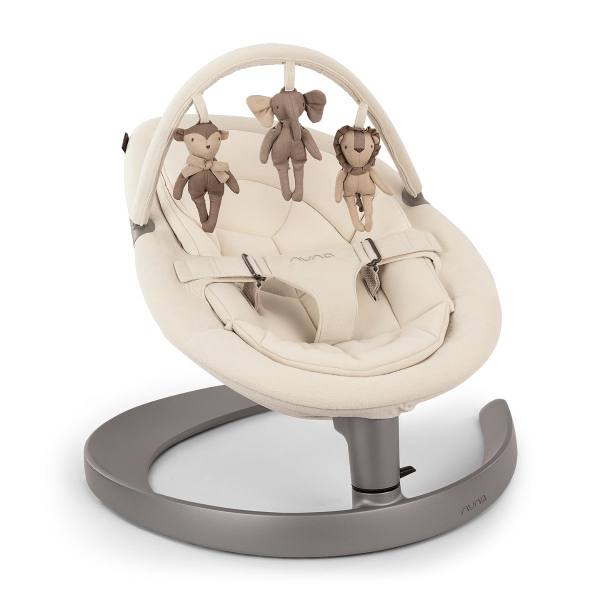 Nuna Leaf Grow baby seat in soft cloud-colored fabric, featuring a sturdy gray base and a toy bar with plush animal toys hanging above.