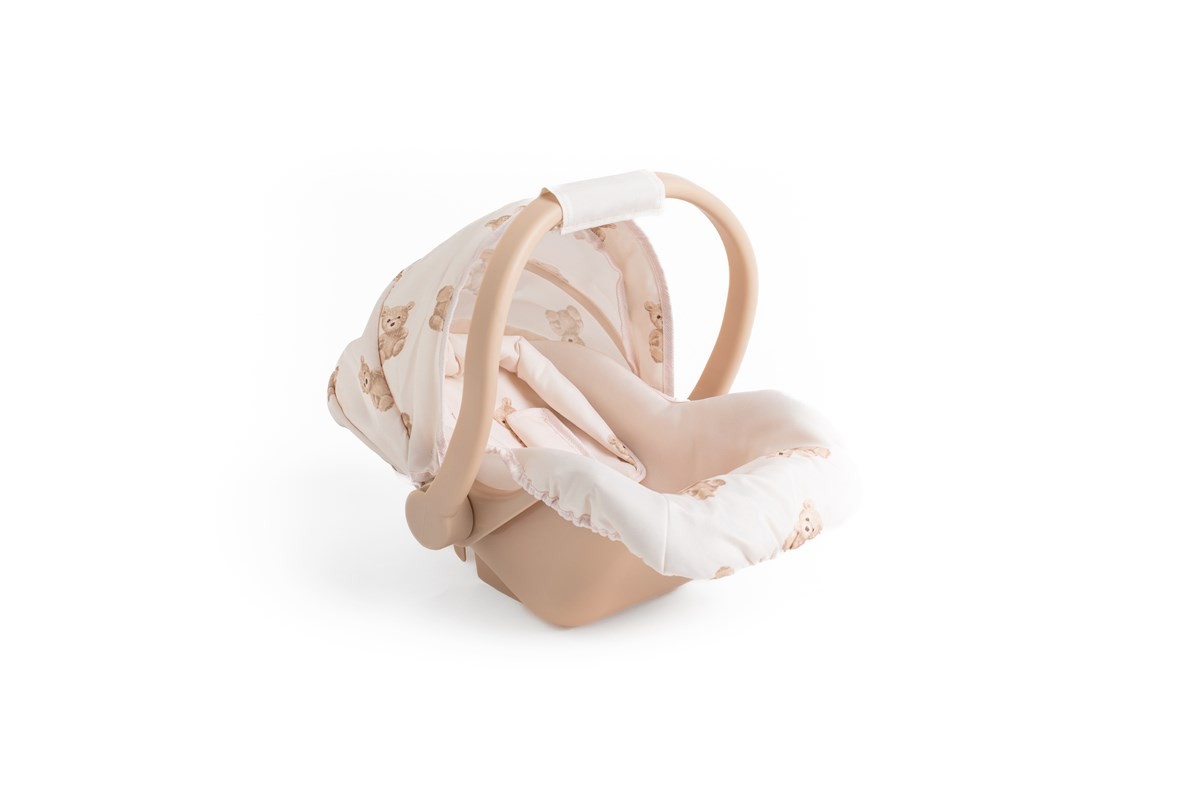 Light beige car seat with a soft teddy bear print fabric, featuring a sturdy handle and a contoured base for safety and comfort.