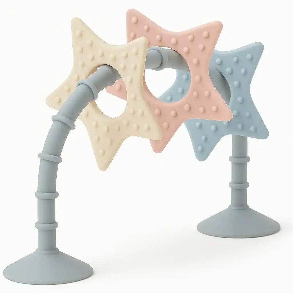 Colorful sensory star toy featuring three textured stars in pastel pink, blue, and cream, attached to a flexible grey base, designed for baths and highchairs.