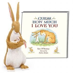 A soft, plush rabbit figurine holds a smaller rabbit, accompanied by a colorful storybook titled "Guess How Much I Love You" featuring illustrations of rabbits.