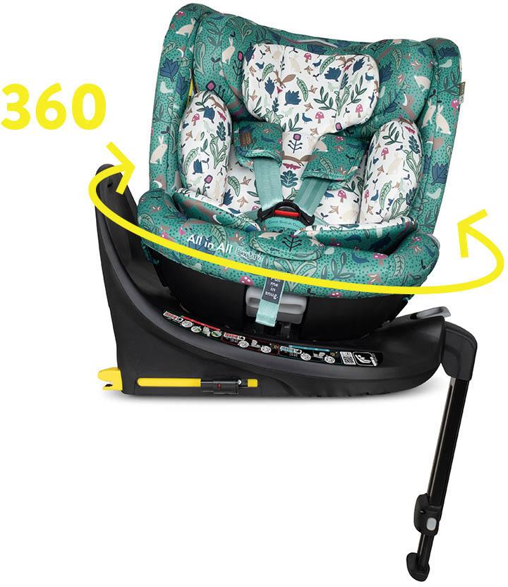 Cosatto All in All Extra i-Size 360 car seat, green with whimsical forest pattern, black base, and yellow rotation arrow.