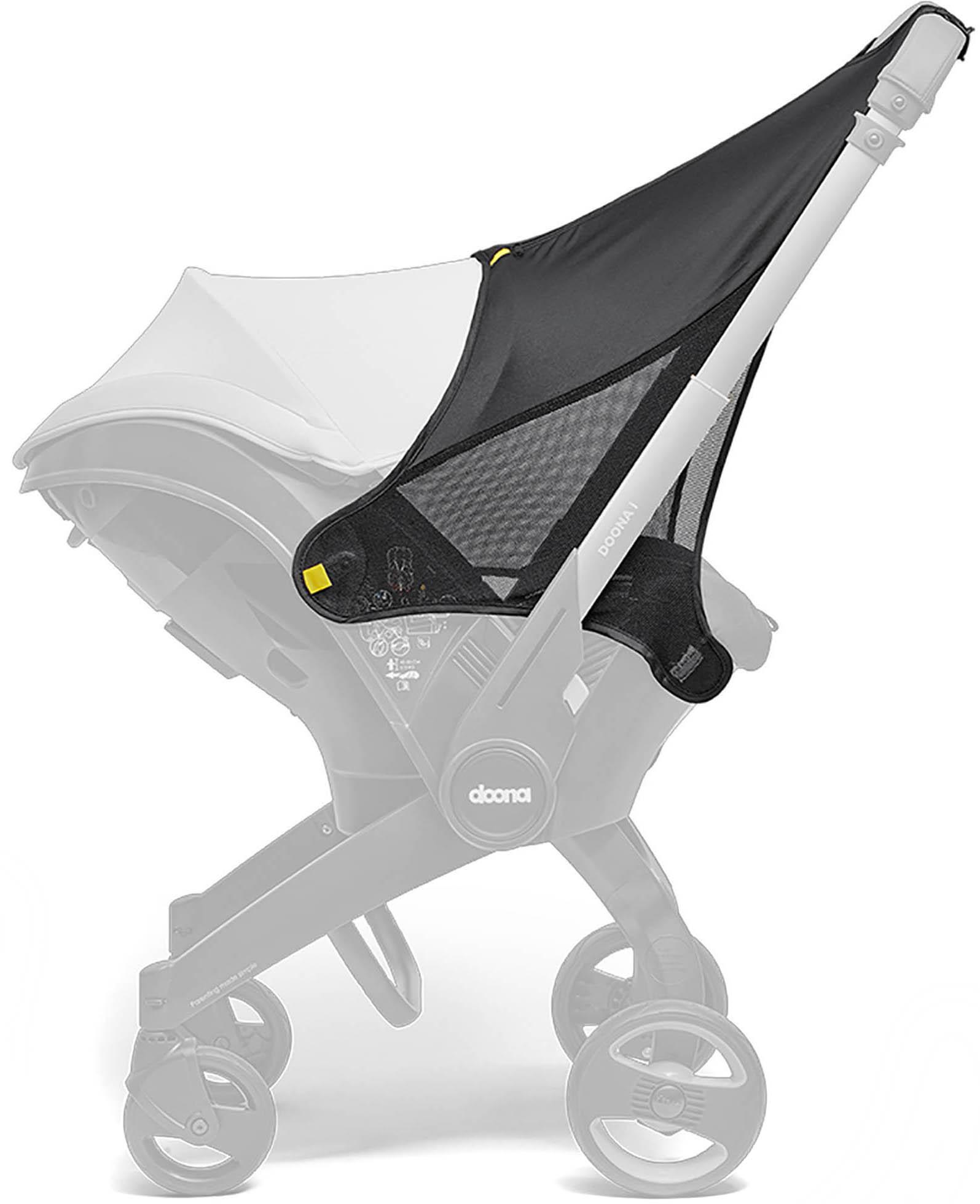 Black Doona sunshade extension with mesh sides and yellow accents, attached to a stroller frame.